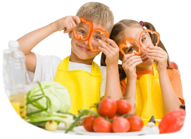 Zwei Kinder mit Paprikabrillen am Familientisch